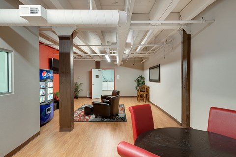 a dining room and living room with a table and chairs